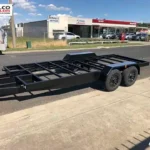 Black tandem tiny home trailer chassis with guards, built in Warragul.
