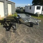 Two tiny home chassis—powder-coated and galvanised—ready for Victorian builds.