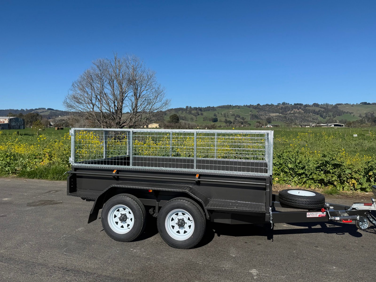 6x4 tandem box trailer with mesh cage and spare wheel, designed by Halco Trailers Melbourne for reliable towing.
